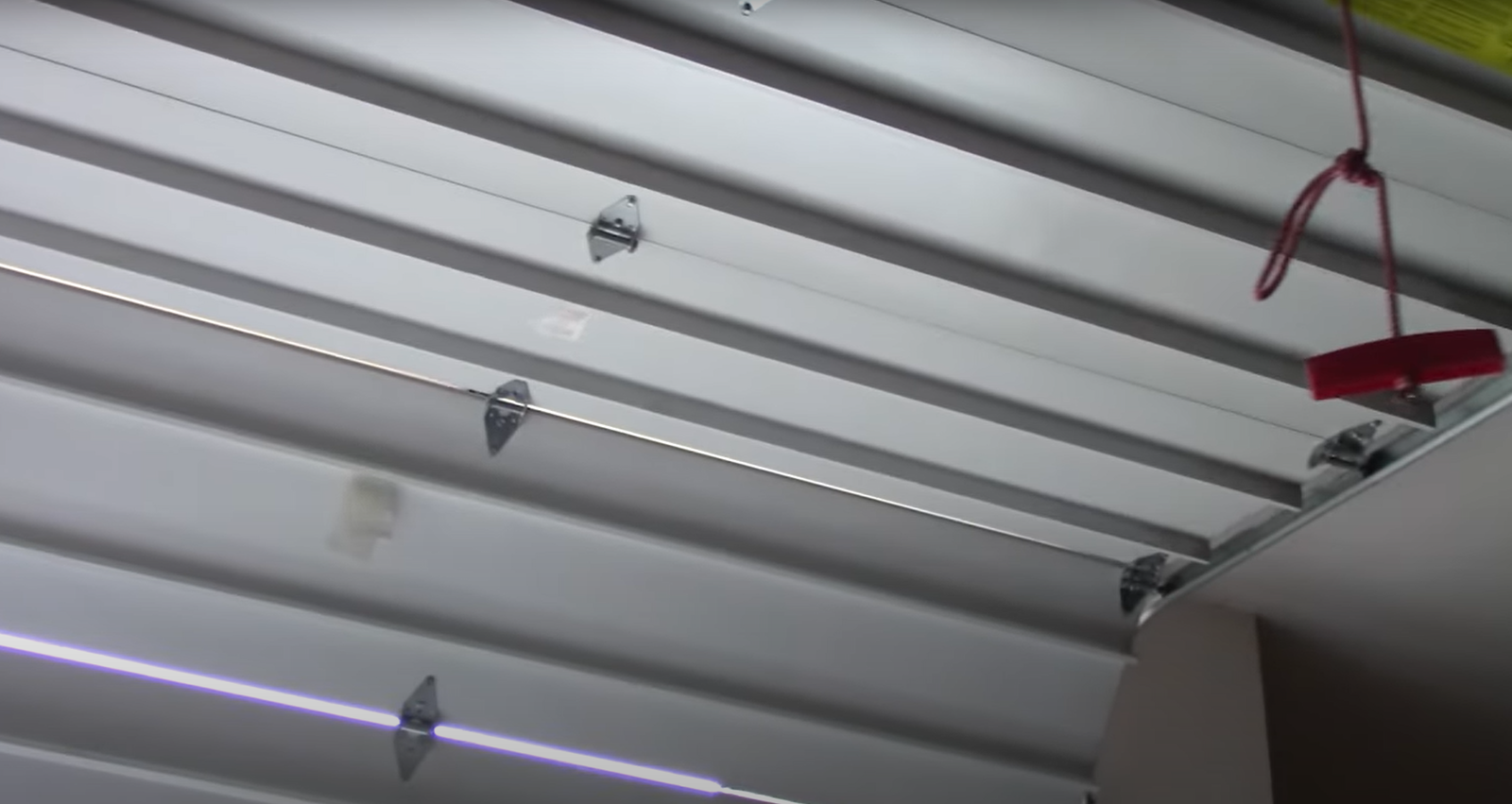 Professional technician installing a new garage door section, highlighting garage door section replacement services in Laurel, Florida