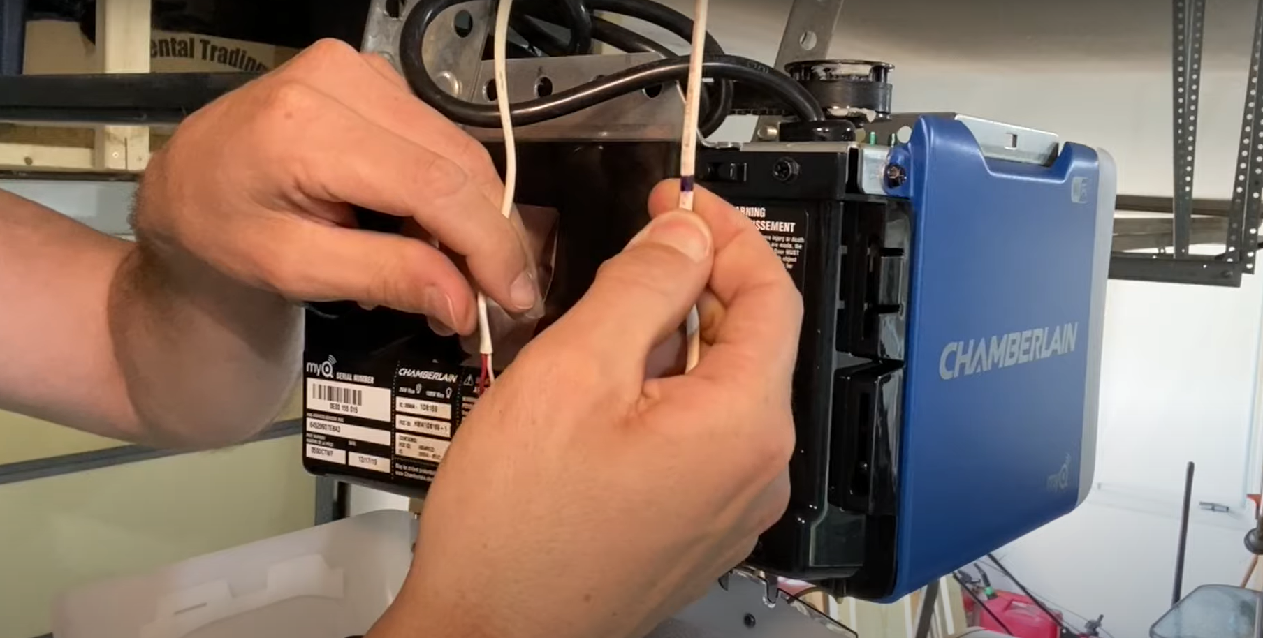 Technician of Garage Door Services Laurel Florida repairing garage door opener.