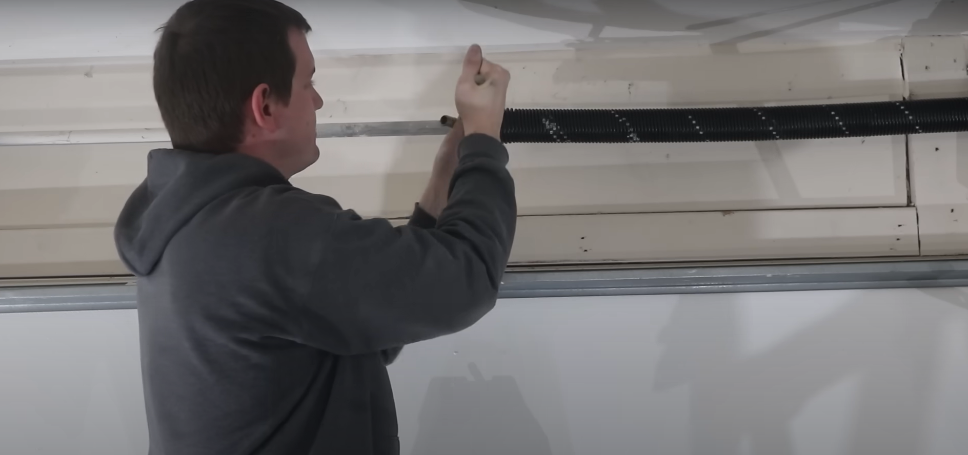 Expert technician of Garage Door Services Laurel Florida fixing garage door cables.